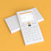 NumWorks graphing calculator with white cover on orange background, Underwood Distributing