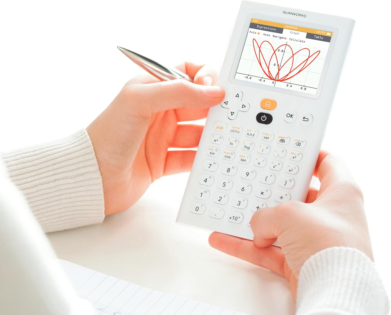 Person using NumWorks graphing calculator, displaying graph, from Underwood Distributing Co.