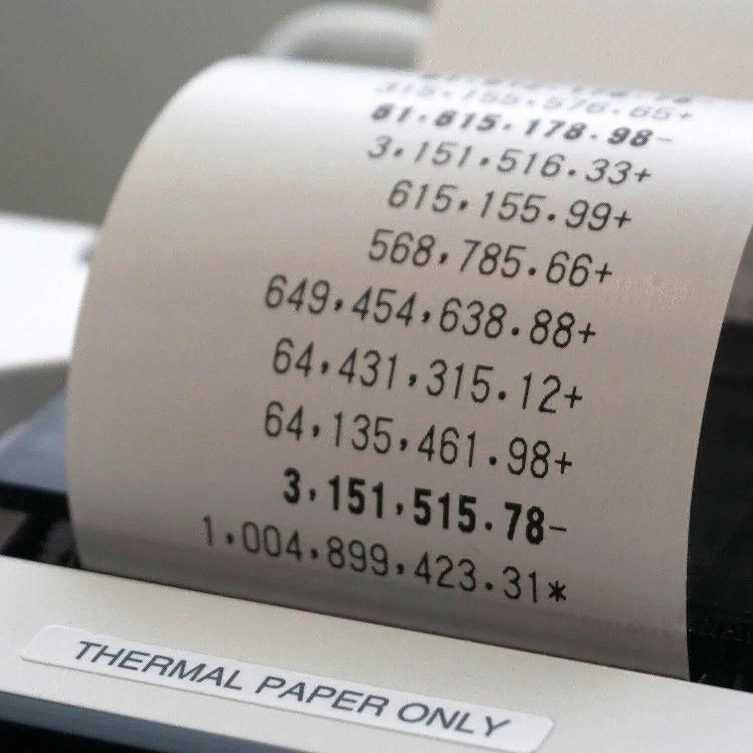 Sharp EL-T3301 12-digit thermal printing calculator showing printed calculations on thermal paper