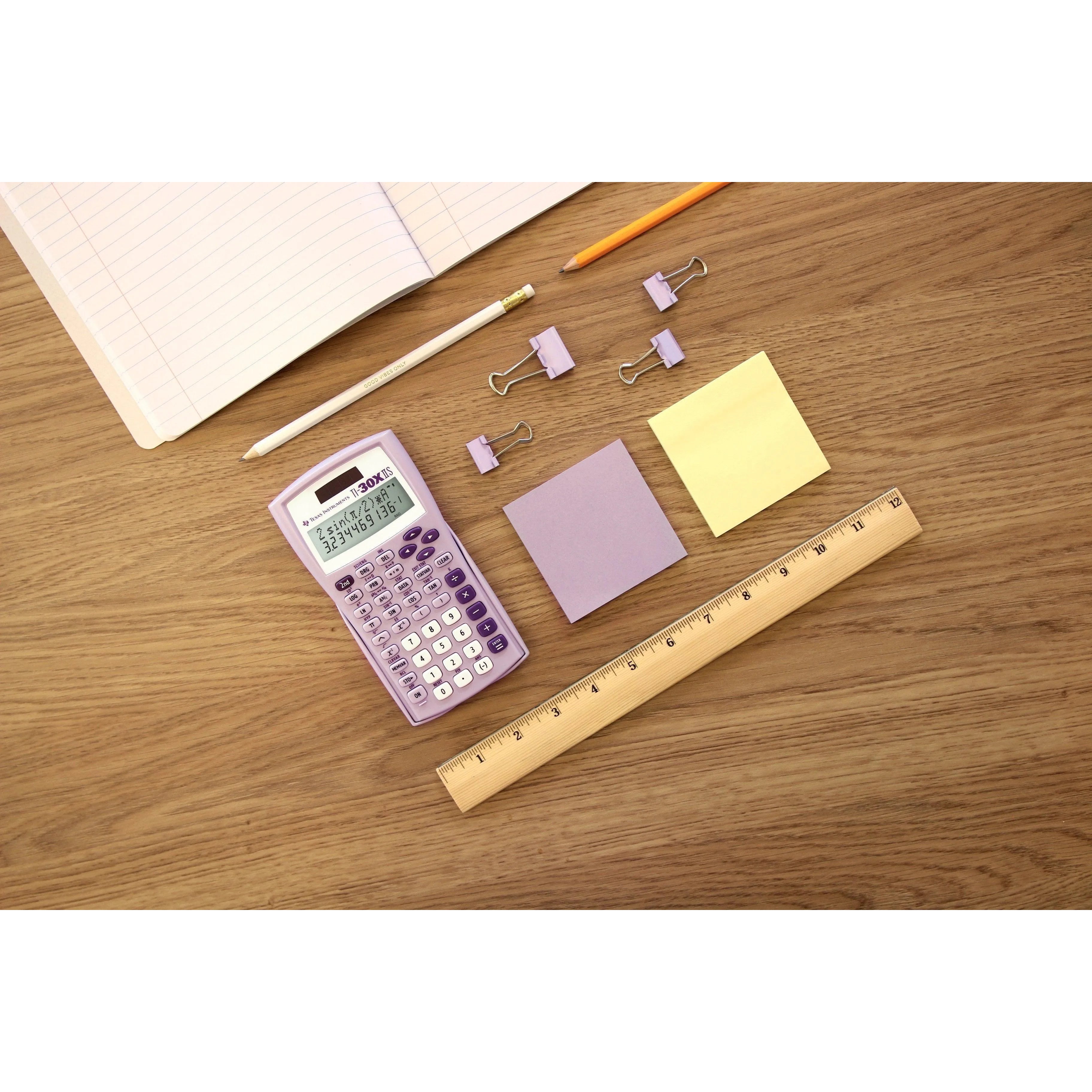 Lavender TI-30XIIS scientific calculator with stationery on wooden desk, Underwood Distributing Co.