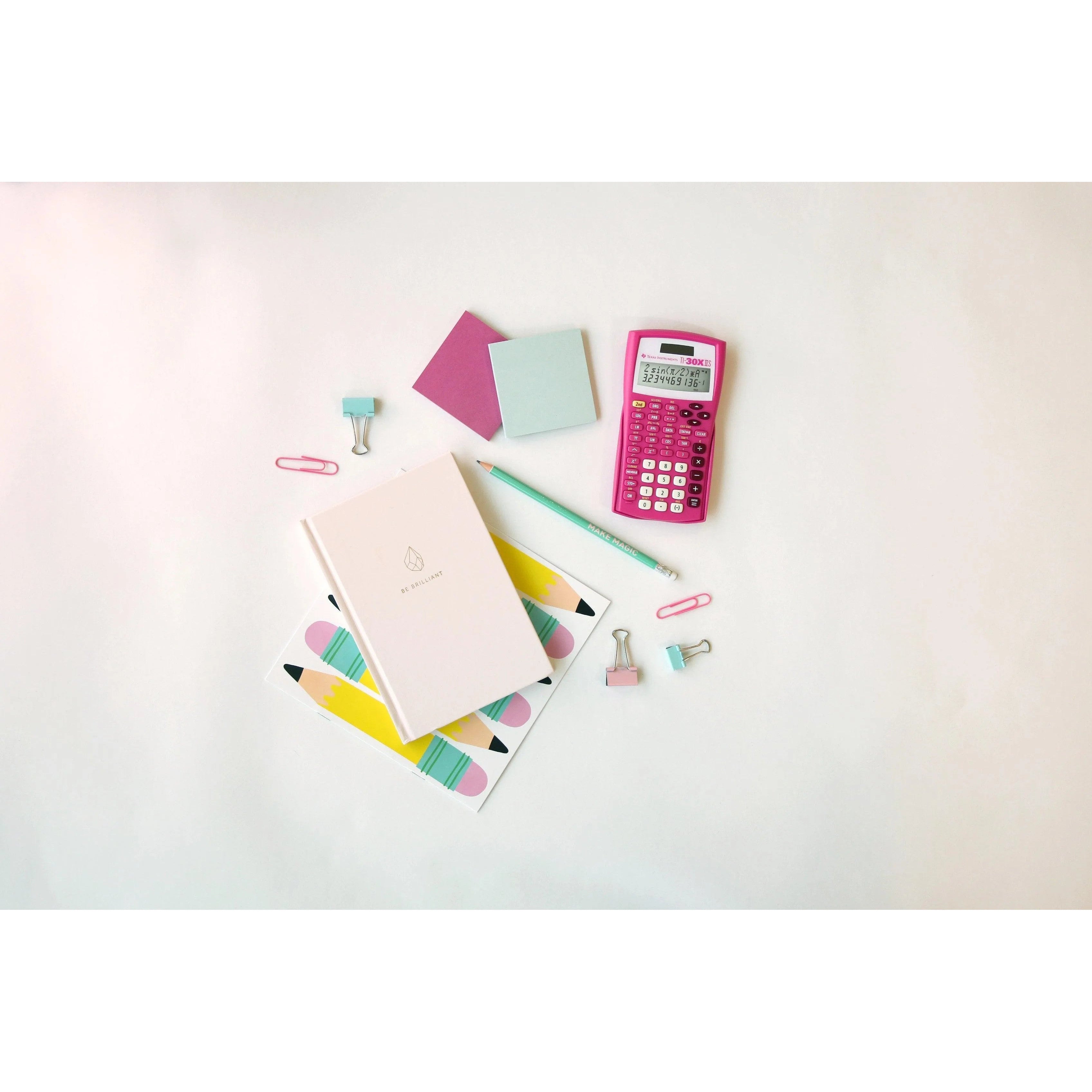 Pink TI-30XIIS scientific calculator with stationery on white desk, Underwood Distributing Co.