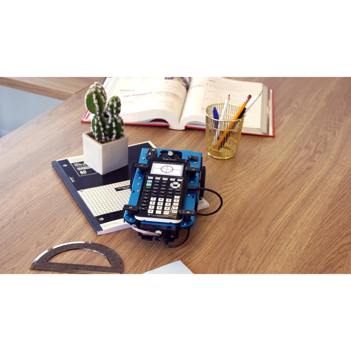 Texas Instruments Innovator Rover with TI-84 calculator on a desk, classroom STEM supplies nearby