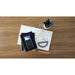 TI-Nspire CX II CAS graphing calculator on desk with math notes, ruler, pencils, and notebooks