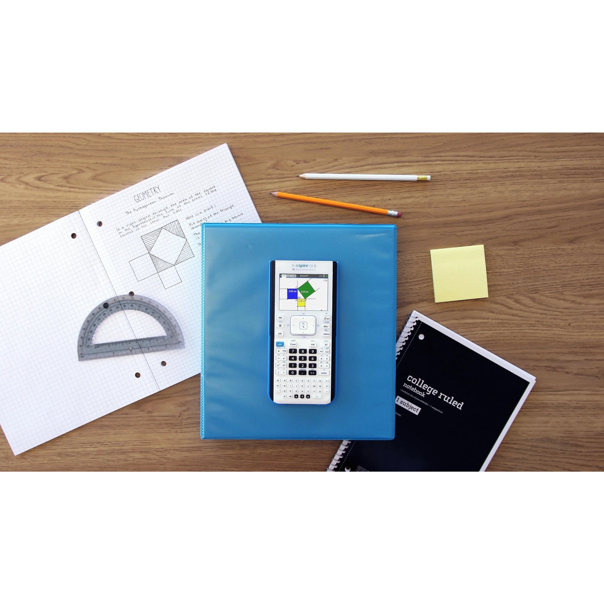 TI-Nspire CX II graphing calculator on blue binder with math supplies and notebooks