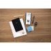 TI-Nspire CX II graphing calculator on wood desk with notebook, planner, and office supplies