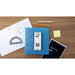TI-Nspire CX II graphing calculator on blue binder with math supplies and notebooks